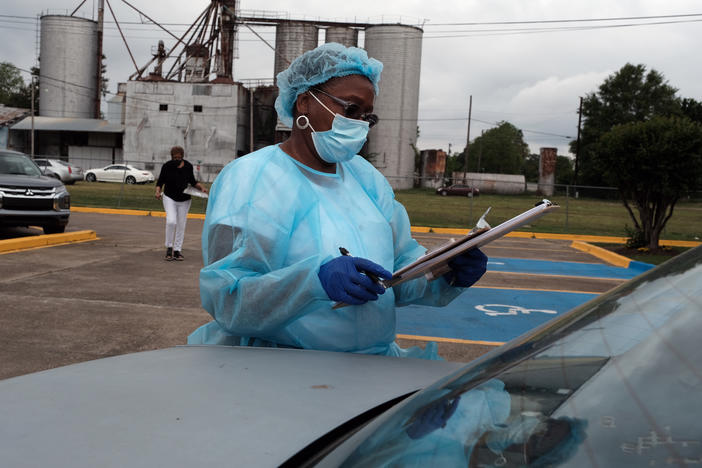 Medical workers with Delta Health Center prepare to vaccinate people in Leland, Miss., last week. In some places, rural hospital workers have been slow to get the vaccine themselves.