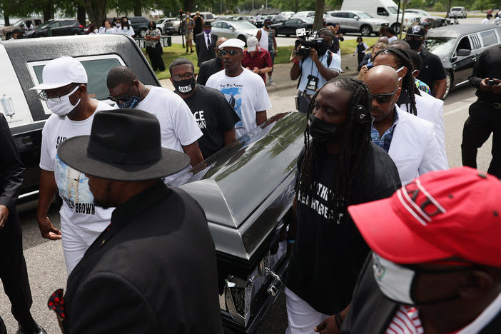 Pallbearers carry Brown's casket to a horse-drawn carriage before his funeral service Monday at the Fountain of Life Church in Elizabeth City, N.C.