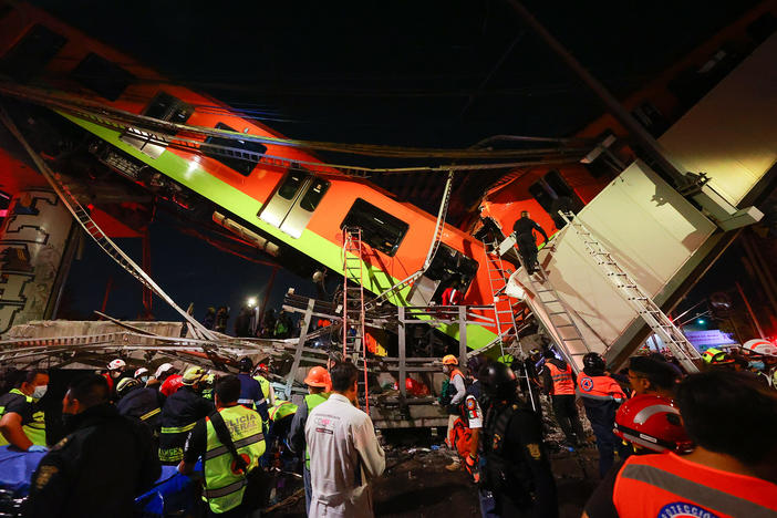 Emergency personnel search for survivors after a raised subway track collapsed Monday night in Mexico City.