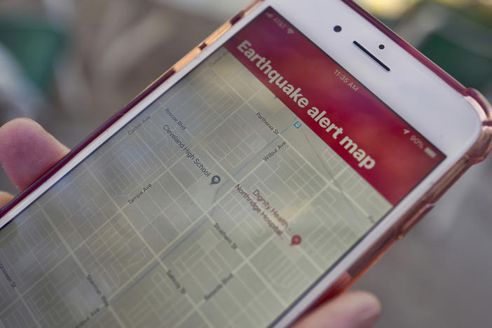 A mobile phone customer in Los Angeles looks at an earthquake warning application on an iPhone. An earthquake early warning system operated by the U.S. Geological Survey has been activated in Oregon, California and now Washington.