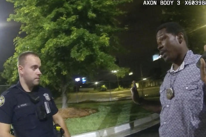 A screen grab taken from body camera video provided by the Atlanta Police Department shows Rayshard Brooks (right) speaking with Garrett Rolfe (left) last June in the parking lot of a Wendy's restaurant in Atlanta.
