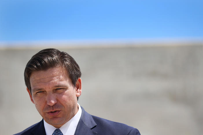 Florida Gov. Ron DeSantis speaks to the media about the cruise industry during a press conference at PortMiami in April. DeSantis faces criticism for failing to do all he could on Florida's biggest environmental threat: climate change.