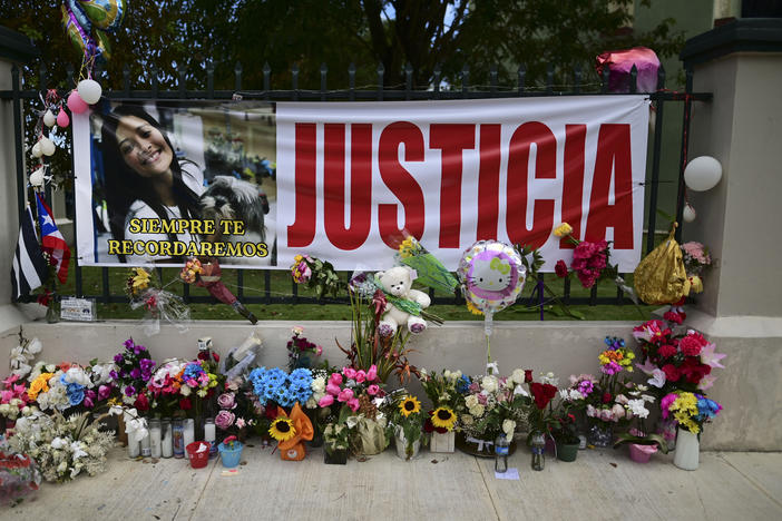 Flowers, balloons and a poster with the Spanish word for "justice" is part of a growing makeshift memorial for Keishla Rodriguez whose lifeless body was found in a lagoon Saturday, at the entrance of where she lived in San Juan, Puerto Rico.