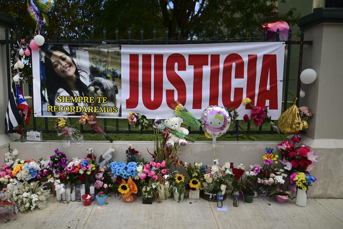 Flowers, balloons and a poster with the Spanish word for "justice" is part of a growing makeshift memorial for Keishla Rodriguez whose lifeless body was found in a lagoon Saturday, at the entrance of where she lived in San Juan, Puerto Rico.