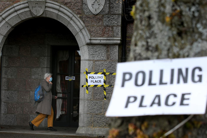 Voters arrive Thursday at the War Memorial building being used as a polling station in Aboyne in Aberdeenshire for Scotland's parliamentary election.