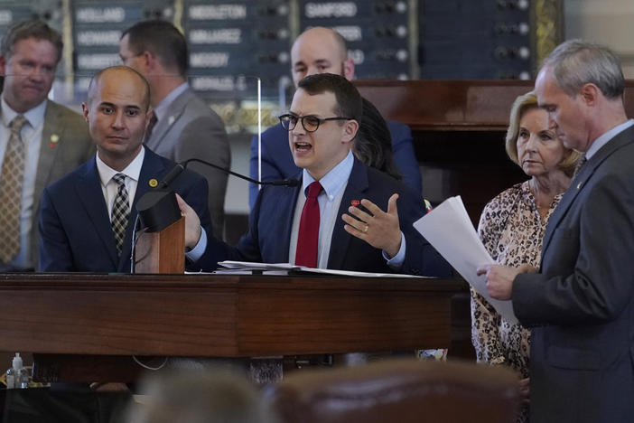 Republican state Rep. Briscoe Cain (center) stands with co-sponsors as he speaks in favor of the election bill Thursday in the House chamber at the Texas Capitol in Austin.