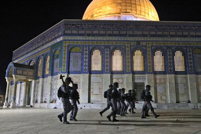 Israeli security forces deploy next to the Dome of the Rock mosque amid clashes with Palestinian protesters at the Al-Aqsa Mosque compound in Jerusalem on Friday.