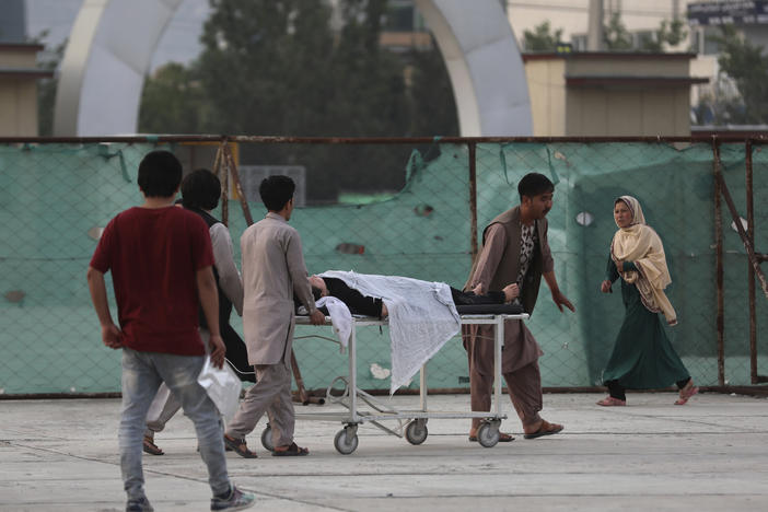 An injured school student is transported to a hospital after a bomb explosion near a school in Kabul, Afghanistan, on Saturday.