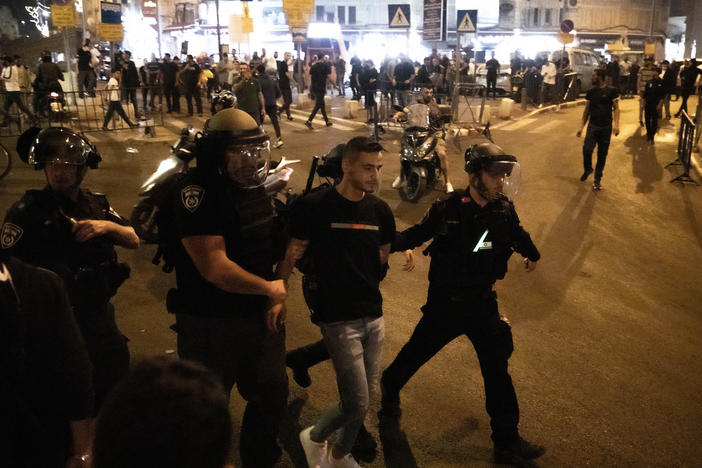 Israeli police take a Palestinian into custody during a protest at the Masjid al-Aqsa compound in East Jerusalem on Sunday.