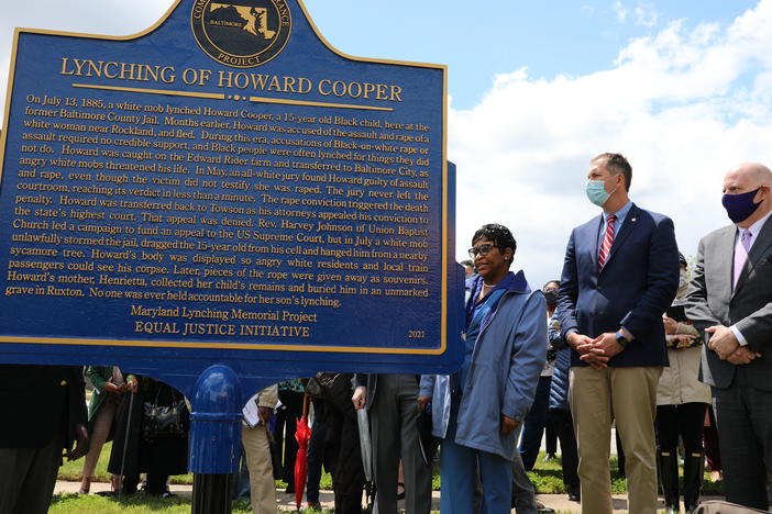 Maryland Gov. Larry Hogan, far right, Baltimore County Executive John Olszewski and Maryland House Speaker Adrienne Jones stand next to a new historic marker on Saturday in Towson, Md., that memorializes Howard Cooper, a 15-year-old who was dragged from a jailhouse and hanged by a mob in 1885.