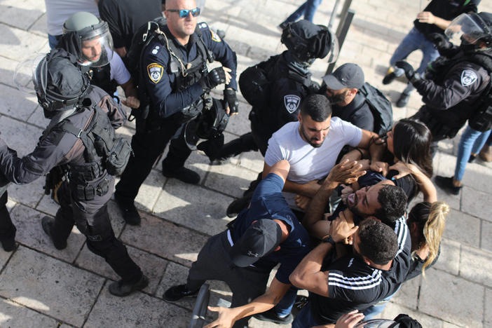 Undercover Israeli security force members arrest a Palestinian protester at Damascus Gate in Jerusalem on Monday.