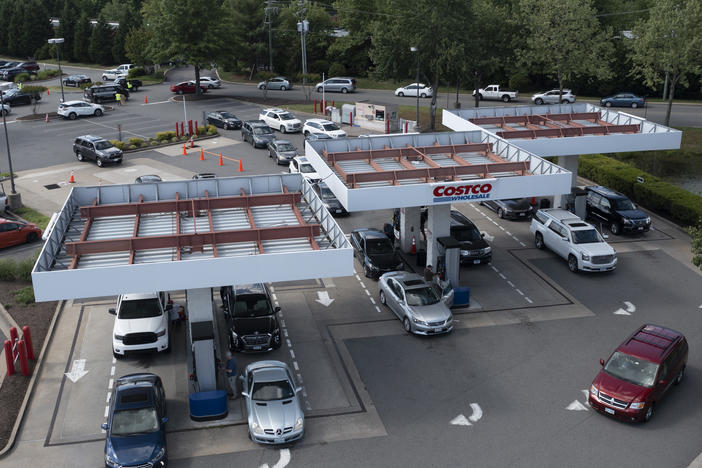 Customers swarm a Costco gas station Tuesday in Richmond, Va., amid fears of a gas shortage. The line at the facility extended around the building.