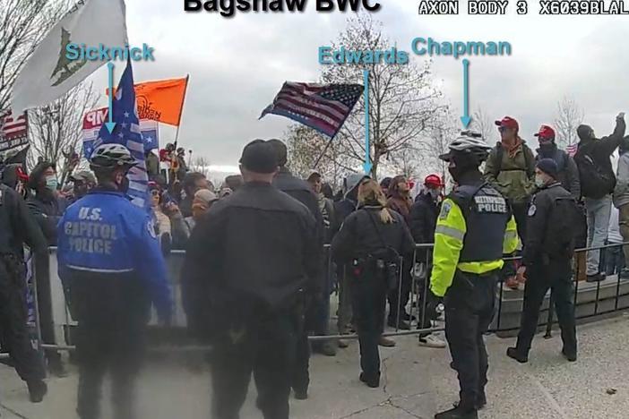 This image from a video released by the Justice Department shows Capitol Police officers, including Brian Sicknick, attempting to hold back a crowd that ultimately breached the U.S. Capitol on Jan. 6.