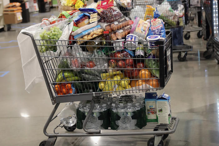 A shopper's cart is full in the checkout line at a ShopRite supermarket in April 2020 in Plainview, N.Y. A year later, prices for most goods have jumped, according to government data, as companies struggle to secure critical raw materials amid supply constraints.