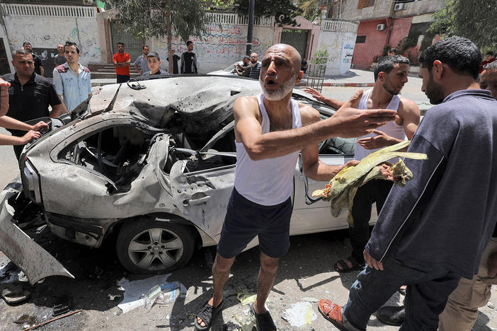 In Gaza City on Wednesday, Palestinians inspect a vehicle destroyed by an Israeli airstrike after the bodies of its passengers and driver were retrieved.