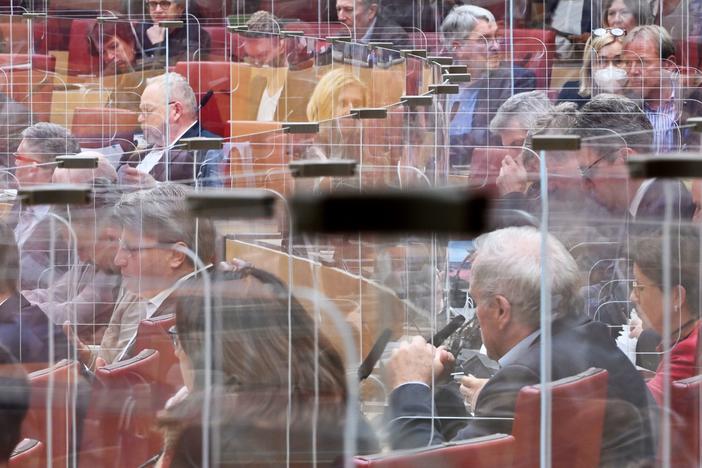 Calling COVID-19 "a terrible wake-up call," an independent review panel says national and international leaders failed to respond adequately to the pandemic. Here, members of the Bavarian state Parliament sit among clear panels in Munich in October.