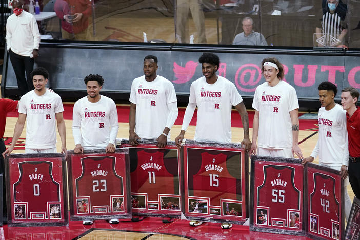 Senior night at Rutgers, where graduating seniors received framed jerseys and applause at the last home game of their careers. Though graduation rates have improved over time, Black basketball players in the NCAA's top division graduate at a rate about 13 percentage points lower than their white teammates.