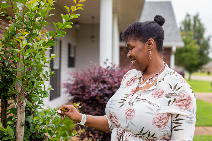 Tia Cunningham says she was able to get out of subsidized housing and use the money as a down payment to buy a house.