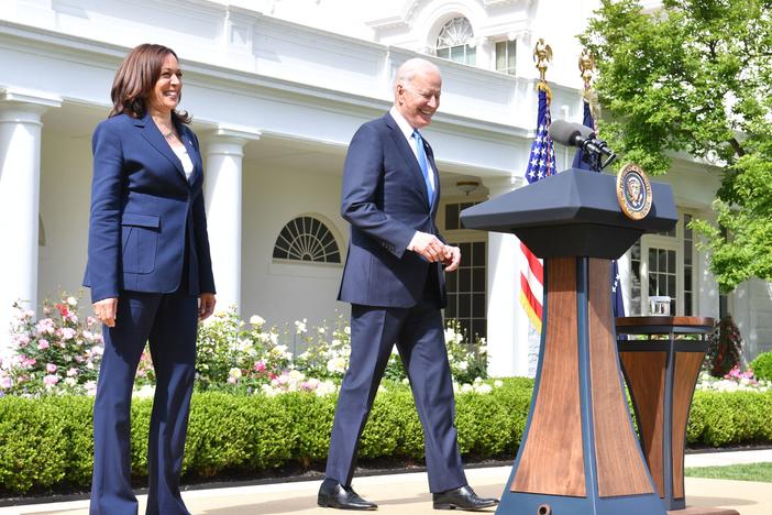 President Biden arrives with Vice President Harris to discuss the CDC's new mask guidance in the Rose Garden of the White House on Thursday.