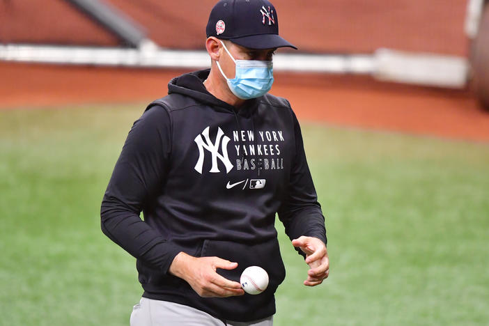 The New York Yankees, including manager Aaron Boone, are back to wearing masks after the team reported eight "breakthrough" COVID-19 cases this week.