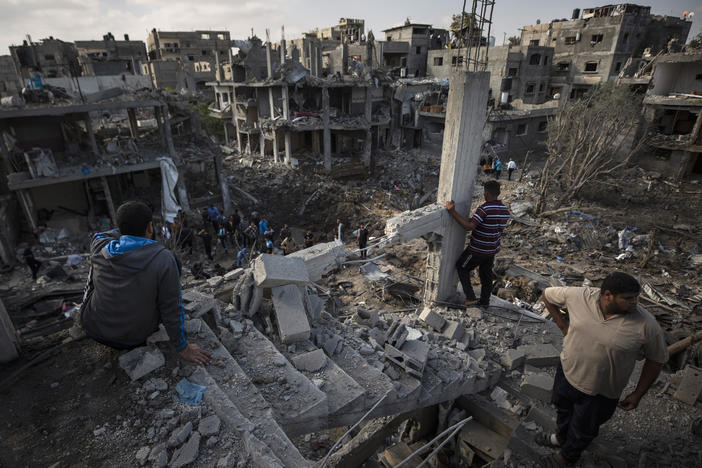 Palestinians inspect their destroyed houses Friday following overnight Israeli airstrikes in Beit Hanoun in the northern Gaza Strip.