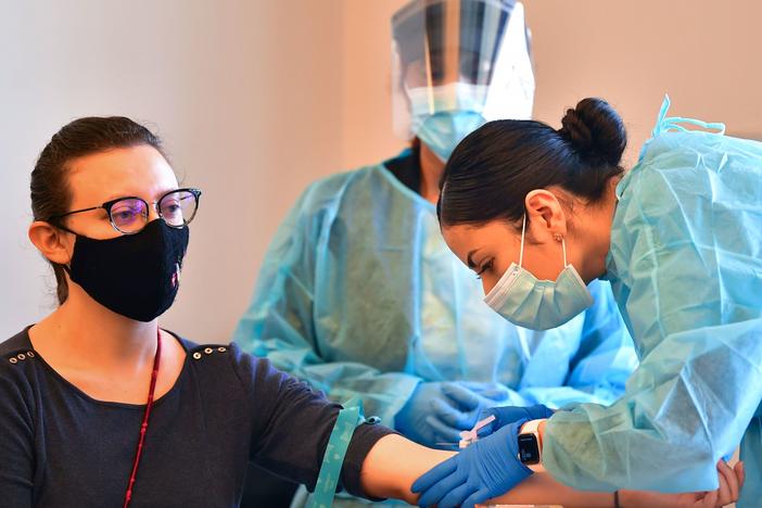 A phlebotomist draws blood at a free COVID-19 antibody testing event on Feb.17 in Pico Rivera, Calif.