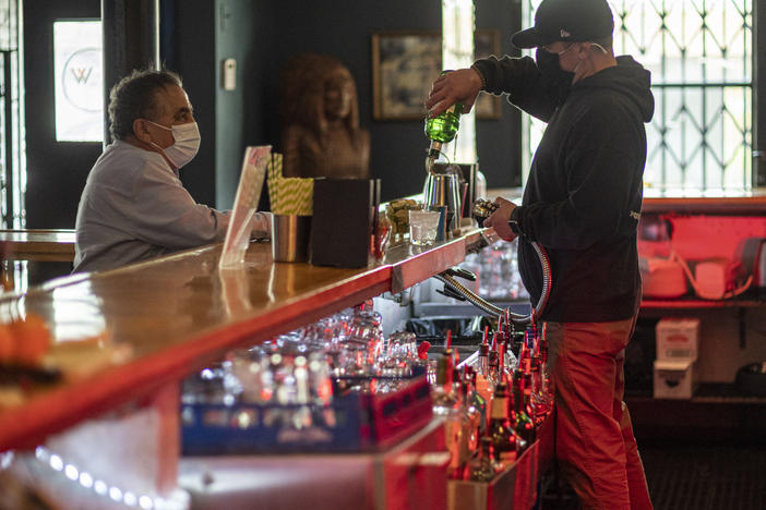 A bartender mixes a drink inside a bar last week in San Francisco. The latest retail sales data out on Friday showed an increase in sales at restaurants and bars as more people venture out amid the continued reopening of the U.S. economy.