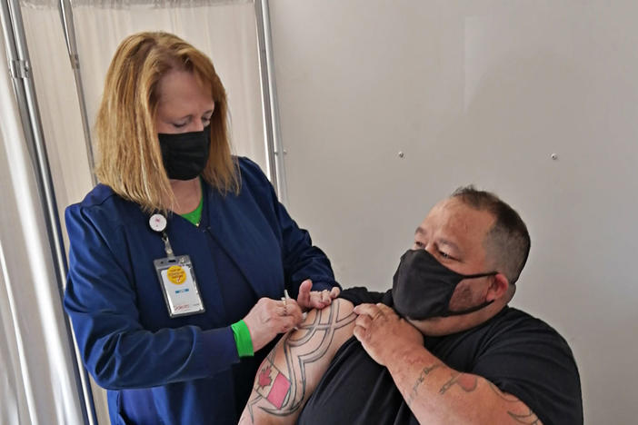 John Harrower, a truck driver from the Canadian province of Manitoba, receives a COVID-19 vaccine shot in North Dakota in late April.