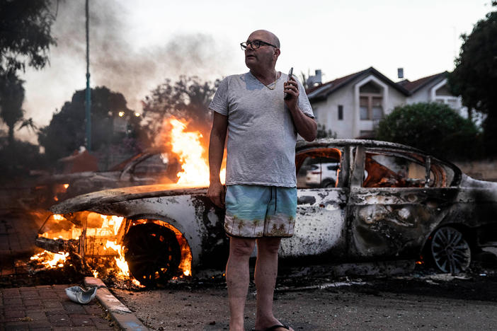 Jacob Simona stands by his burning car during clashes with Israeli Arabs and police in the mixed Jewish-Palestinian city of Lod, Israel, on Tuesday.
