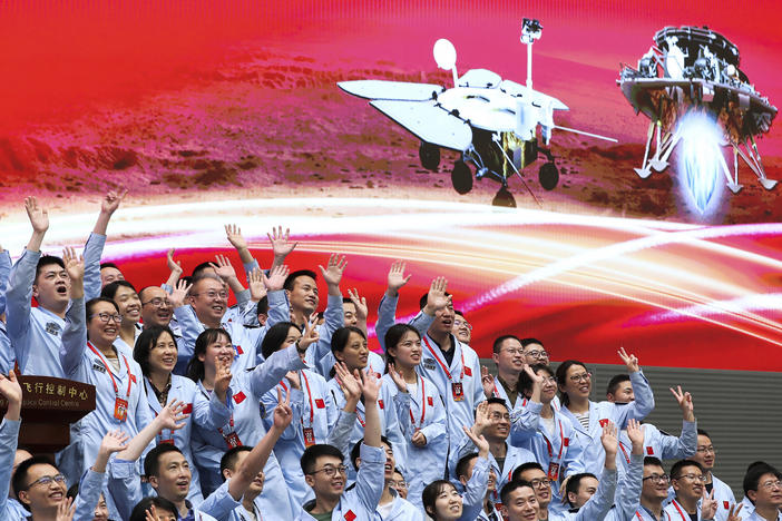 In this photo released by Xinhua News Agency, members at the Beijing Aerospace Control Center celebrate after China's Tianwen-1 probe successfully landed on Mars, at the center in Beijing, Saturday, May 15, 2021.
