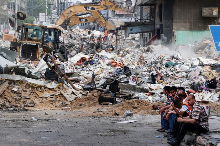 An excavator clears the rubble of a destroyed building in Gaza City on Sunday, following Israeli airstrikes.