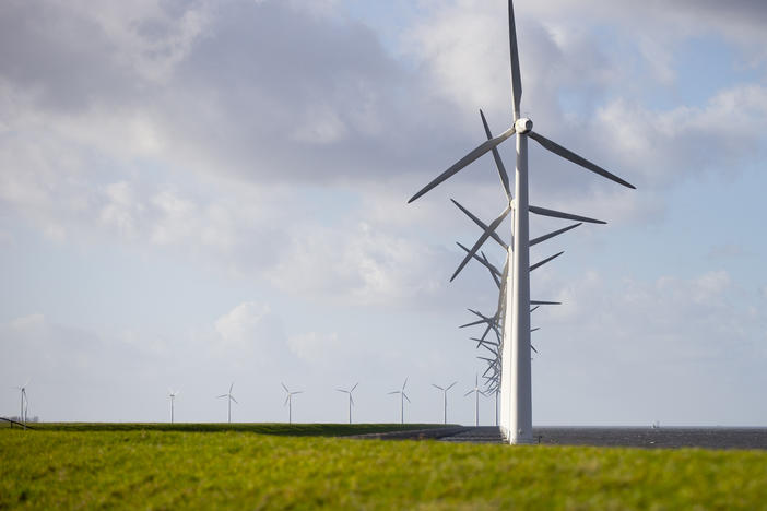A new International Energy Agency report on climate change calls for halting approval of all new coal power plants this year. Here, wind turbines are seen on a dike near Urk, Netherlands, in January.