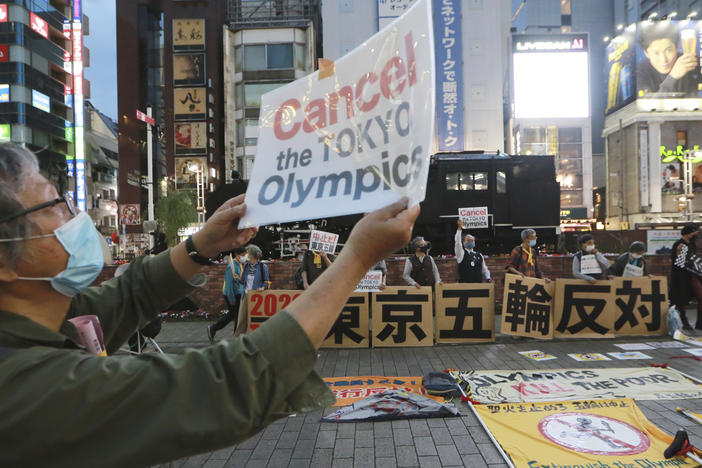 A demonstrator holds a placard during an anti-Olympics demonstration in Tokyo on Monday. A prominent doctors association has joined calls to cancel the Summer Games in Tokyo.