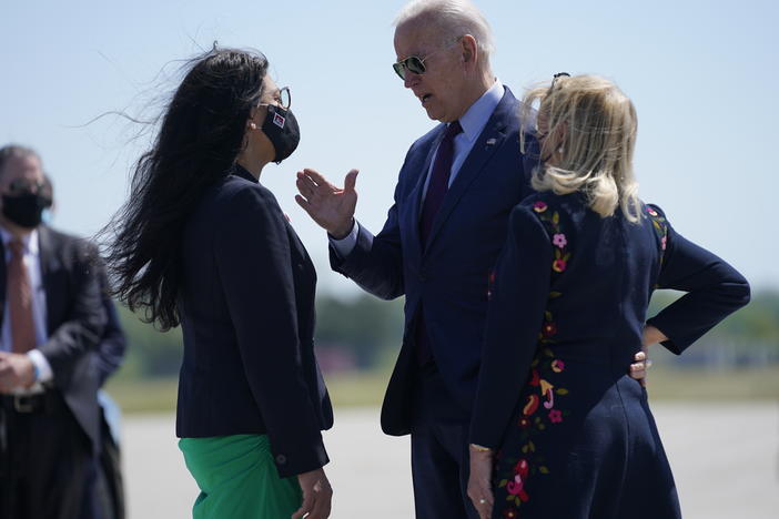 President Biden speaks with Rep. Rashida Tlaib (left) and Rep. Debbie Dingell as he arrives in Detroit on Tuesday.