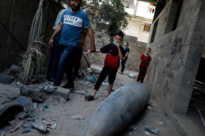 Palestinians look at an unexploded bomb dropped by an Israeli F-16 warplane on Gaza City's Rimal neighbourhood on Tuesday.