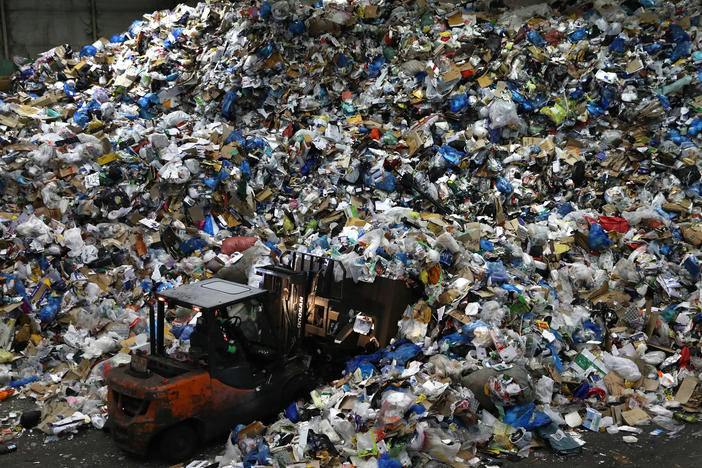 A worker operates a forklift to move household waste at a facility that stores recyclable materials in Seoul, South Korea. In 2019, more than 130 million metric tons of single-use plastics were thrown away, according to a new report.