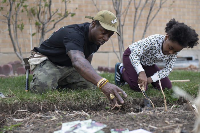 Ietef "DJ Cavem Moetavation" Vita plants seeds with daughter Libya LeaDonvita in the garden at their home outside Denver. Vita is among a growing list of Black gardening enthusiasts-turned-entrepreneurs across the country who've launched seed businesses during the pandemic-inspired gardening boom.