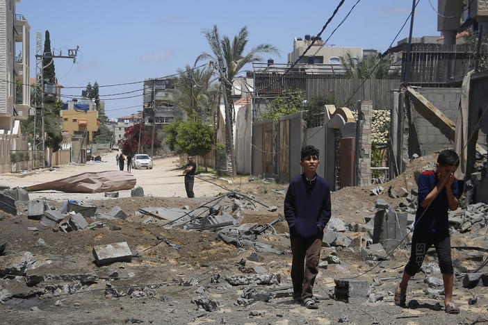 Palestinian children walk past the rubble of a house hit by Israeli airstrikes this week in Beit Lahyia in the northern Gaza Strip.