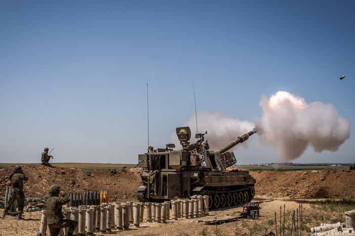 Israeli artillery fires toward the Gaza Strip from a position at the Israeli-Gaza border near Sderot on Wednesday.