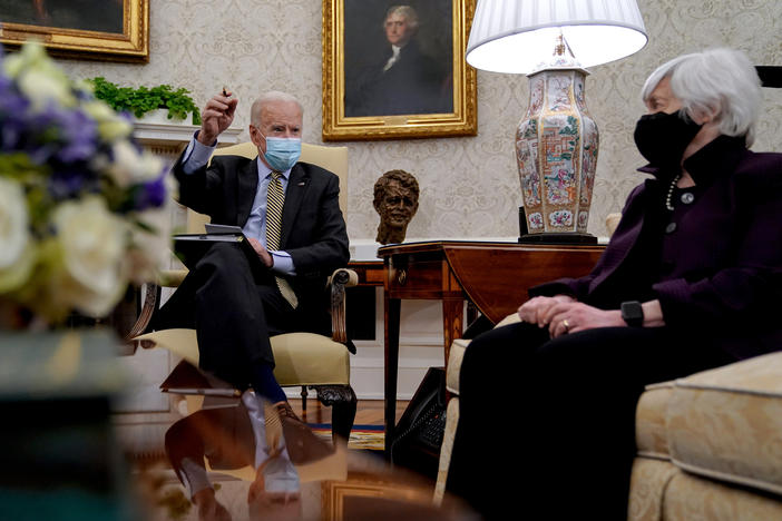 President Biden speaks as Treasury Secretary Janet Yellen listens during the weekly economic briefing in the Oval Office at the White House on April 9. Biden issued an executive order compelling Yellen and other regulators to assess the risk of climate change to America's financial system.