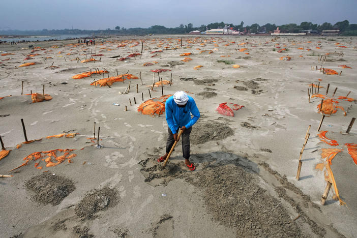 Rains have washed away the top layer of sand of shallow graves at a cremation ground on the banks of the Ganges River in Shringverpur, northwest of Allahabad, Uttar Pradesh, India. Coronavirus testing is limited in parts of rural India, but some of the people buried there are believed to have died of COVID-19.