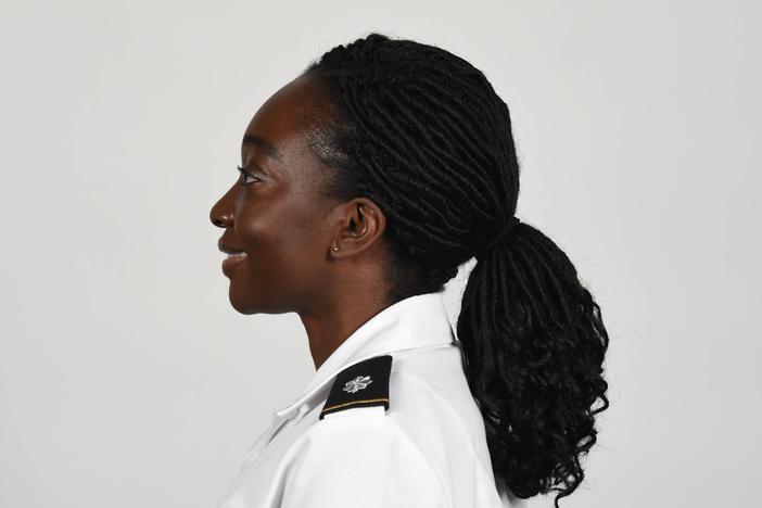 An Army photo shows a soldier wearing a new approved ponytail hairstyle.