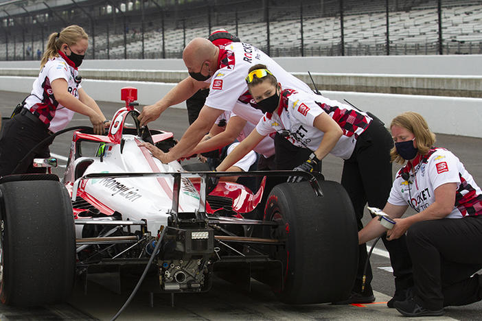 Paretta Autosport crew members work on their car in pit lane at the Indianapolis Motor Speedway during a practice session earlier this week. It could become the first majority-women team to qualify for the Indy 500.
