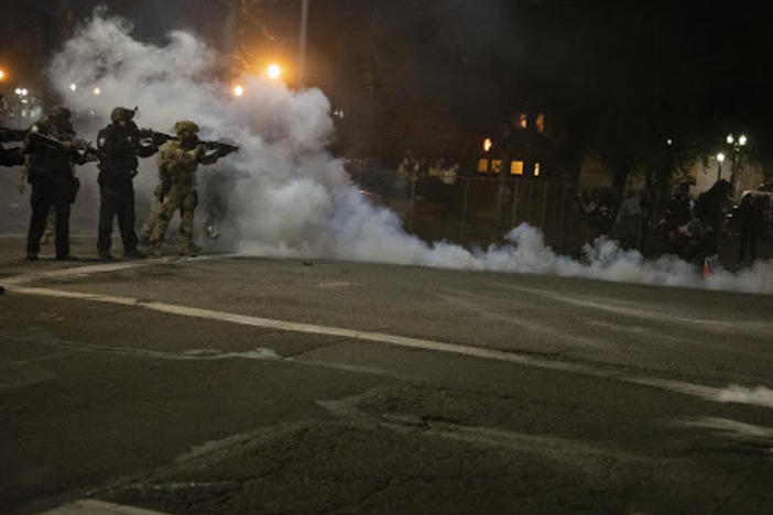 Federal law enforcement officers fire impact munitions and tear gas at protesters demonstrating against racism and police violence in front of the Mark O. Hatfield federal courthouse in Portland, Ore., on July 16, 2020. Through the end of 2020, the majority of last year's federal civil disorder charges were filed in Oregon.