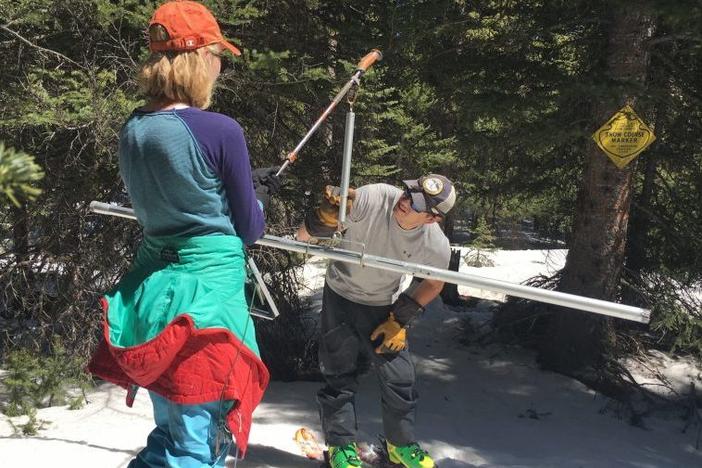 Colorado Snow Survey supervisor Brian Domonkos and civil engineer Madison Gutekunst of the USDA weigh snow to know how much moisture it holds on April 30, 2021.