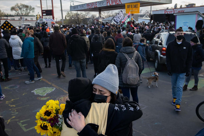 People embrace after the verdict is announced in the trial of former Minneapolis police officer Derek Chauvin at George Floyd Square in Minneapolis, Minn.