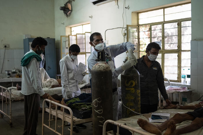 Medical attendant Gurmesh Kumawat prepares to administer supplemental oxygen to a coronavirus patient in the emergency ward at the BDM Government Hospital in mid-May in Kotputli, India.