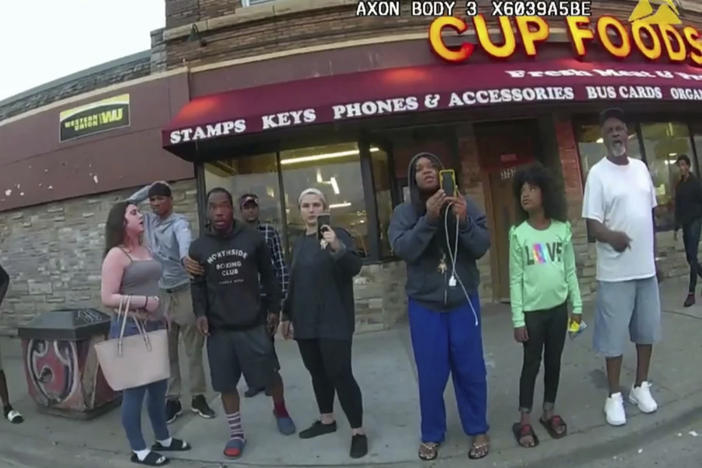 This image from a police body camera shows bystanders including Darnella Frazier (third from right) as Derek Chauvin, who was a police officer at the time, pressed his knee on George Floyd's neck in Minneapolis.