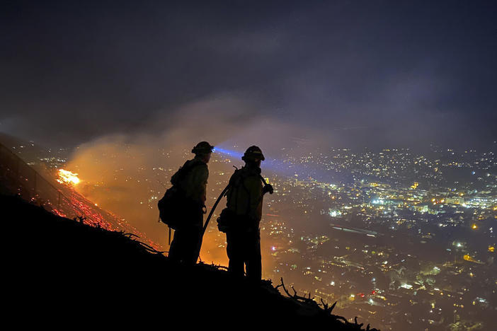 Firefighters battle a brush fire last week in Santa Barbara, Calif. Climate-driven droughts make large, destructive fires more likely around the world. Scientists warn that humans are on track to cause catastrophic global warming this century.