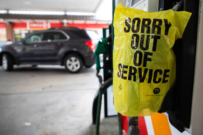 A gas pump is marked "out of service" as cars line up May 11 at a Circle K in Charlotte, N.C., following a ransomware attack that shut down Colonial Pipeline.